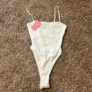 an edikted white body suit brand new white with a cute pattern and lace